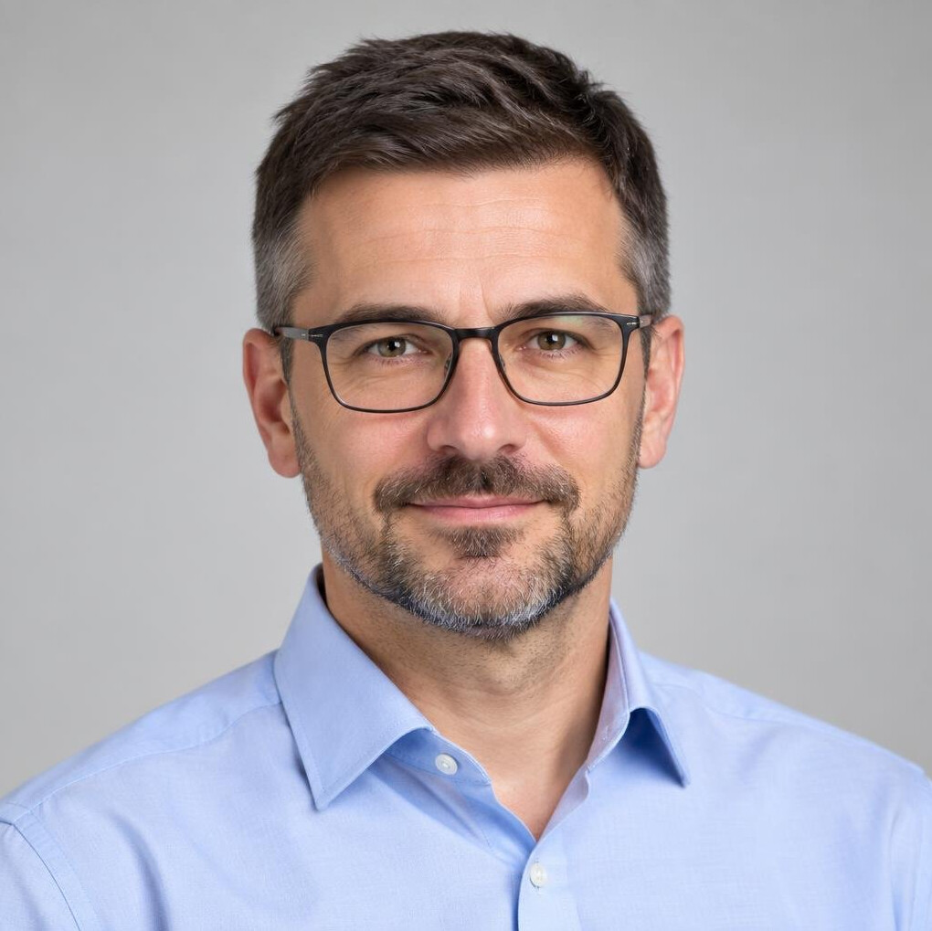 Studio portrait of a middle-aged European man with glasses