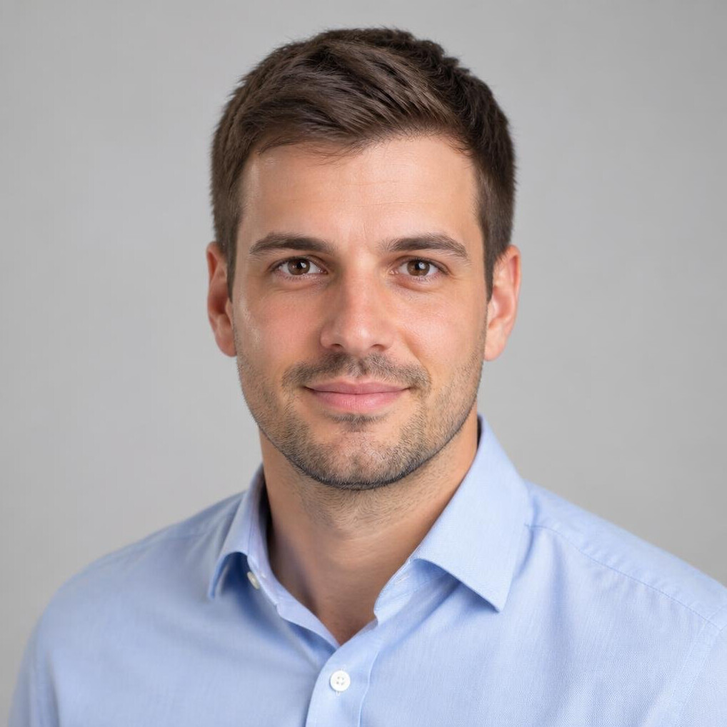 Studio portrait of a young European man with short hair in business casual attire